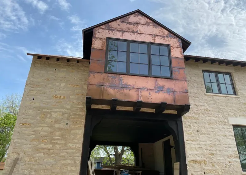 Copper metal panel facade on a stone building for Metal Roof Coating in Ridgefield