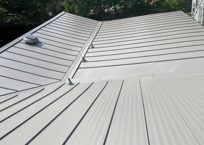 Solar attic fan installed on a metal roof for Roof Ventilation in Ridgefield